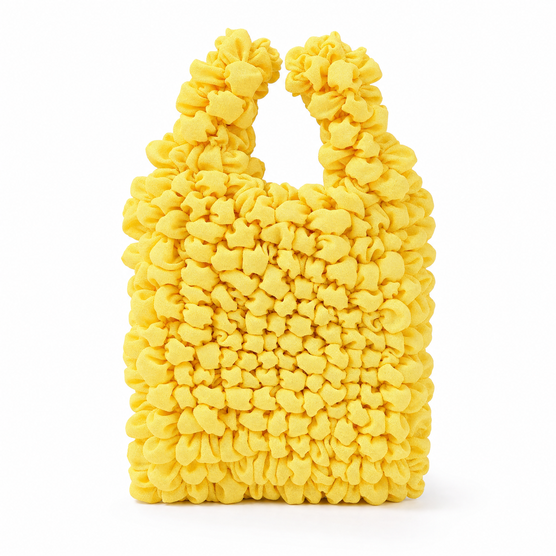 A bright yellow textured shoulder bag with a chunky, puffy boucle-like surface and integrated top handles, shown on a plain white background.